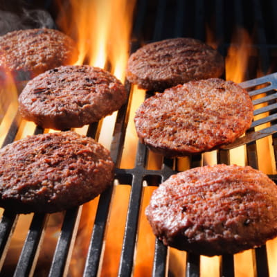 Hamburgers being cooked on a grill