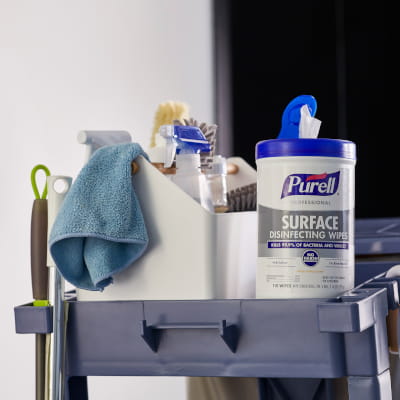 Janitor cart full of cleaning products, including PURELL Surface Disinfecting Wipes 